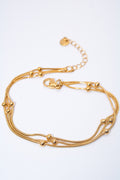 Pulsera malla triple con bolitas — baño dorado
