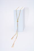 Collar lariat triángulos geométricos — baño dorado