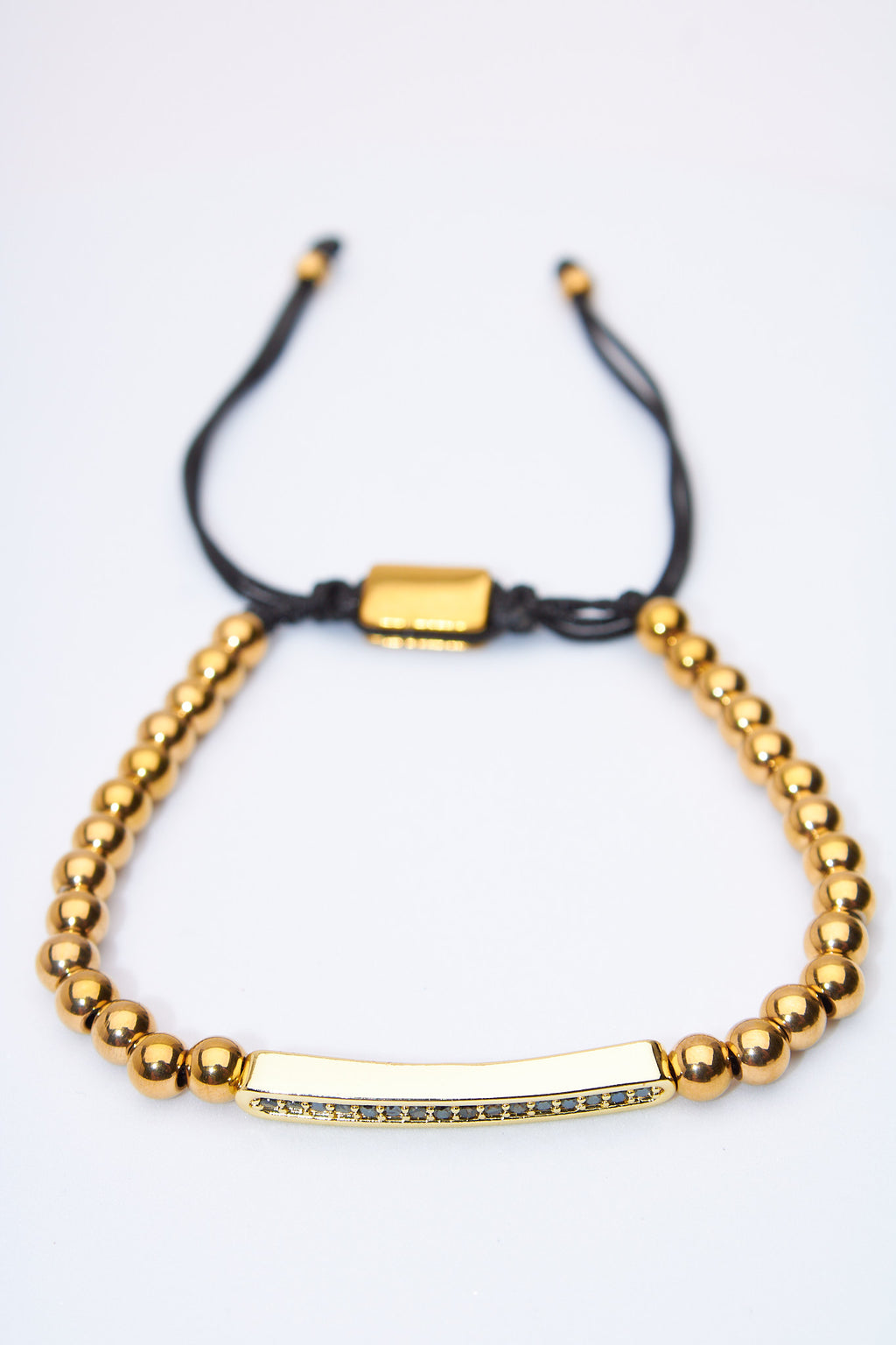 Pulsera ajustable de bolitas doradas con barra pavé